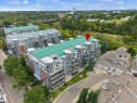 Multi-story building featuring balconies, a green roof, and exterior landscaping - #505 7839 96 St Nw, Edmonton, AB 