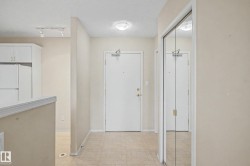 Entryway featuring tile flooring, mirrored closet doors, and flush-mount lighting - 