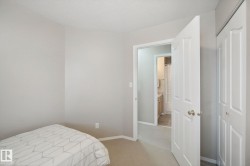 Neutral tone wall paint, carpet flooring, white paneled doors, and a built-in closet - 