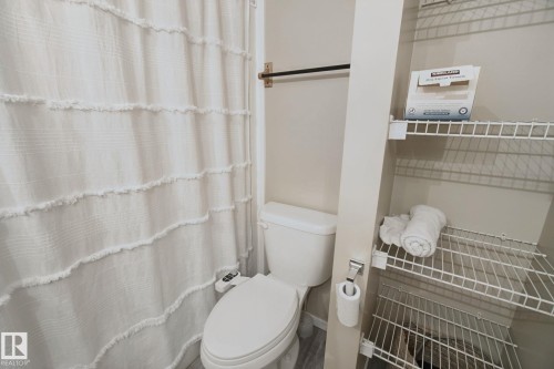 White toilet with an attached bidet - 13912 156 Avenue Nw, Edmonton, AB 