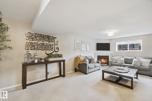 Recessed lighting, corner fireplace, large window, and light-toned carpeting - 13912 156 Avenue Nw, Edmonton, AB 