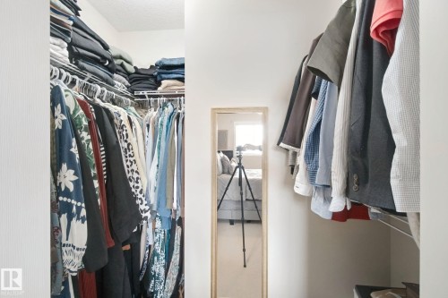 Custom closet system featuring multiple hanging rods and integrated shelving - 13912 156 Avenue Nw, Edmonton, AB 