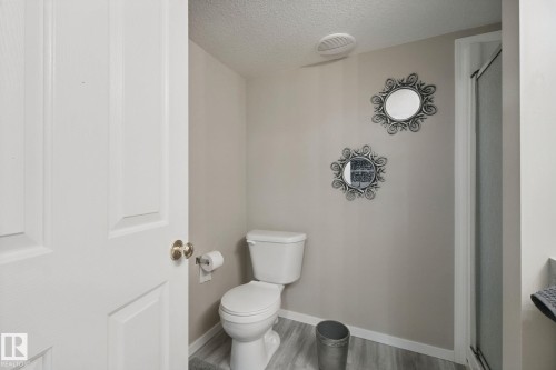 Panel interior door with brass-finish hardware, light gray wall color, and wood-finish flooring - 13912 156 Avenue Nw, Edmonton, AB 