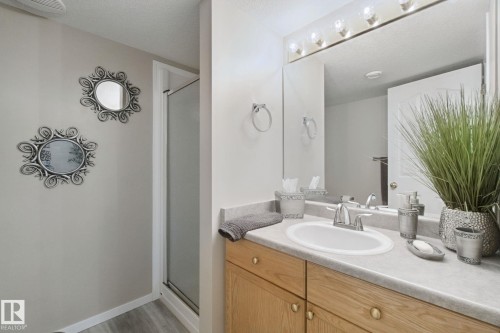 Oak wood-finish vanity with a built-in sink and chrome faucet - 13912 156 Avenue Nw, Edmonton, AB 