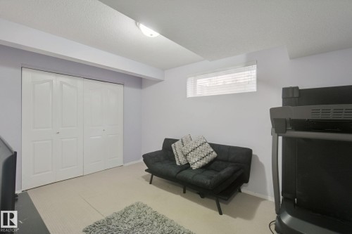 Recessed window with blinds, carpeted flooring, and bi-fold closet doors - 13912 156 Avenue Nw, Edmonton, AB 