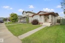 Single-story residence featuring light-colored siding, a brown roof, and a front porch - 13912 156 Avenue Nw, Edmonton, AB 