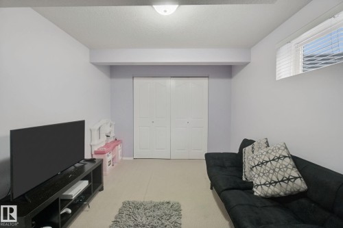 Recessed ceiling light fixture, bi-fold closet doors, and upper window with horizontal blinds - 13912 156 Avenue Nw, Edmonton, AB 