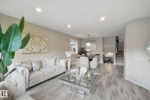 Open-concept living and dining area featuring recessed lighting, wood-finish flooring, and neutral wall tones - 13912 156 Avenue Nw, Edmonton, AB 