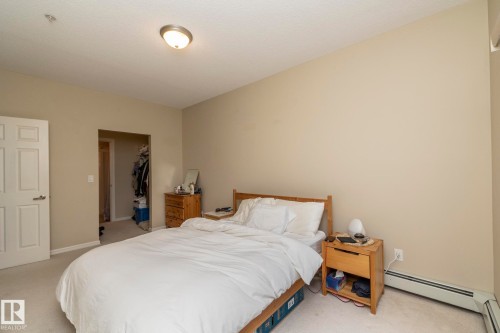 Neutral-toned walls complement the light-colored carpet flooring - #416 263 Macewan Rd Sw, Edmonton, AB 