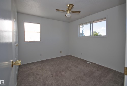 Neutral wall tones, ceiling fan with light fixture, and plush carpeting - 7743 37 Avenue Nw, Edmonton, AB 