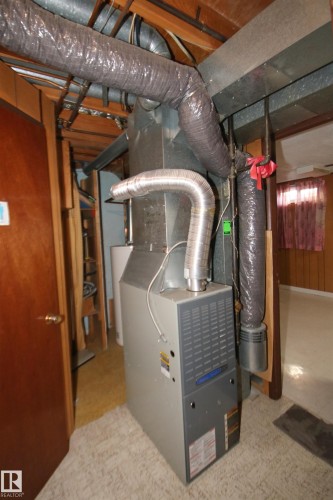 Central HVAC unit with exposed ductwork and wood ceiling joists - 7743 37 Avenue Nw, Edmonton, AB 