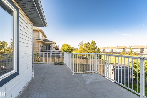 Concrete patio with white railing - 1254 Mcallister Way Sw, Edmonton, AB 