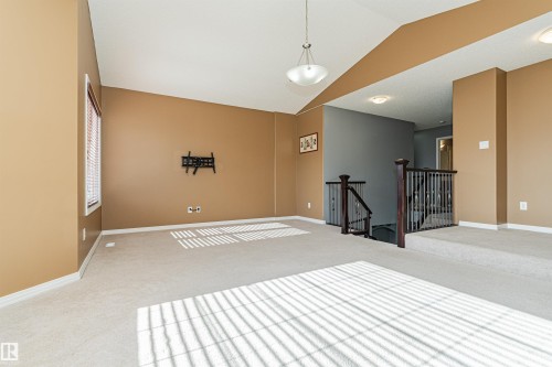 Vaulted ceiling with an attached pendant light fixture - 1254 Mcallister Way Sw, Edmonton, AB 