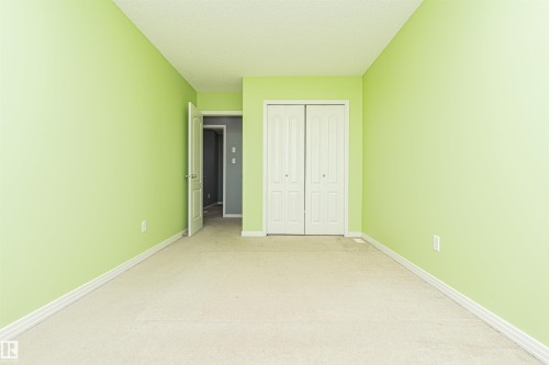 Wall-to-wall carpeting, bi-fold closet doors, and painted walls - 1254 Mcallister Way Sw, Edmonton, AB 