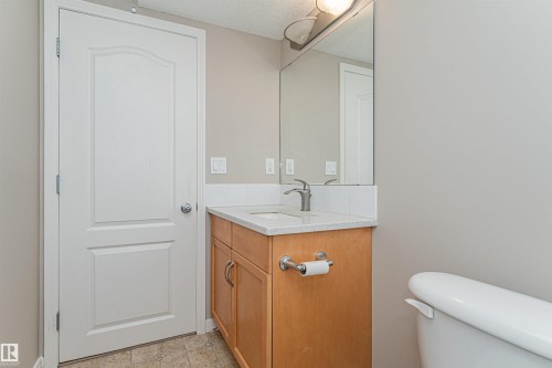 Light wood-finish vanity with a light-colored countertop and undermount sink - 1254 Mcallister Way Sw, Edmonton, AB 