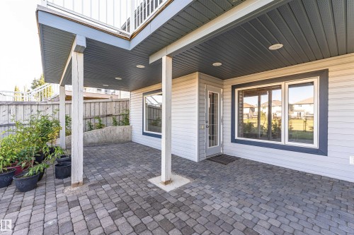 Covered patio featuring paver flooring, recessed lighting, and direct exterior access - 1254 Mcallister Way Sw, Edmonton, AB 