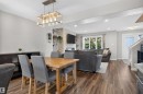 Wood-finish flooring throughout, recessed lighting, and a modern rectangular chandelier - 319 Desrochers Boulevard Sw, Edmonton, AB 