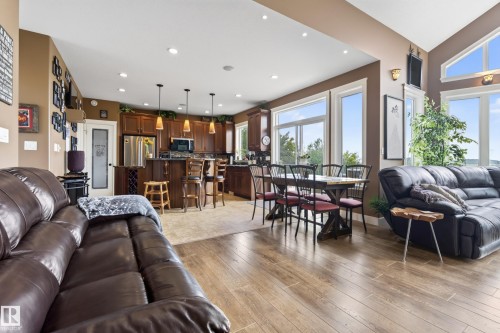 Open-concept living area featuring wood-finish flooring, recessed lighting, and a kitchen with dark wood cabinetry - 48109 Rr 155, Rural Beaver County, AB - Indoor Photo Showing Living Room