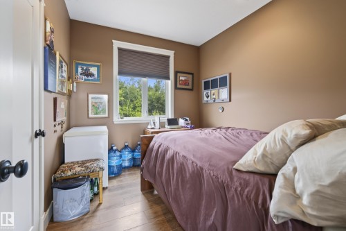 Room featuring wood-finish flooring and neutral-toned walls - 48109 Rr 155, Rural Beaver County, AB - Indoor Photo Showing Bedroom