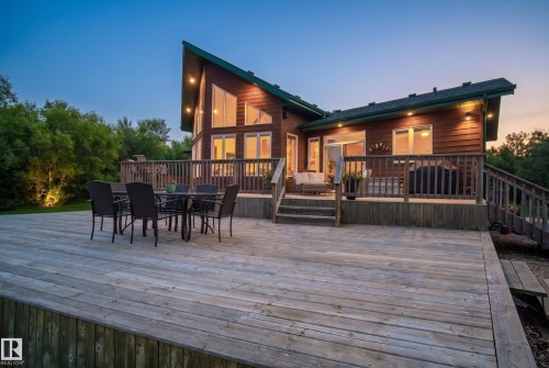 Expansive multi-level wood decking surrounds a modern wood-sided residence - 48109 Rr 155, Rural Beaver County, AB - Outdoor With Deck Patio Veranda With Exterior