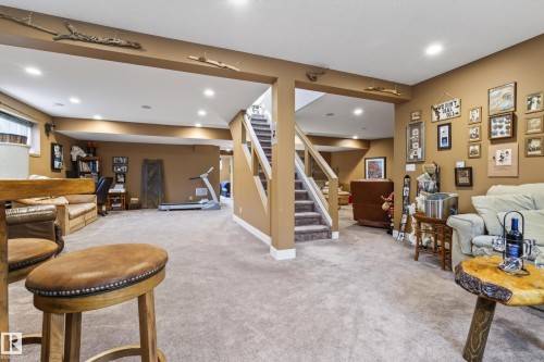 Carpeted lower level featuring recessed lighting and a staircase with white risers and wood handrails - 48109 Rr 155, Rural Beaver County, AB - Indoor