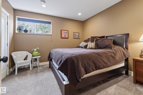 Carpeted bedroom featuring a low-profile window with a roller blind - 48109 Rr 155, Rural Beaver County, AB - Indoor Photo Showing Bedroom