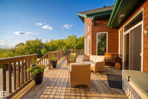 Expansive wood-plank deck featuring a full railing, multiple access points to the residence, and a multi-level design - 48109 Rr 155, Rural Beaver County, AB - Outdoor With Deck Patio Veranda With Exterior