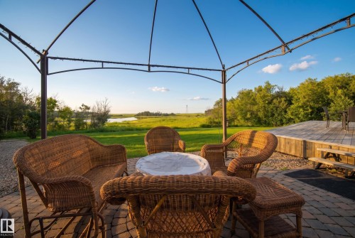 Expansive outdoor patio featuring paver stones, a metal gazebo frame, and a wooden deck - 48109 Rr 155, Rural Beaver County, AB - Outdoor With Deck Patio Veranda With View