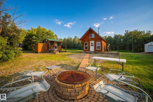 Stone fire pit with paver surround - 48109 Rr 155, Rural Beaver County, AB - Outdoor With Deck Patio Veranda