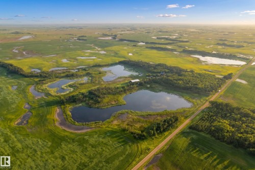 Expansive agricultural landscape featuring numerous natural water bodies, green fields, and clusters of mature trees - 48109 Rr 155, Rural Beaver County, AB - Outdoor With View