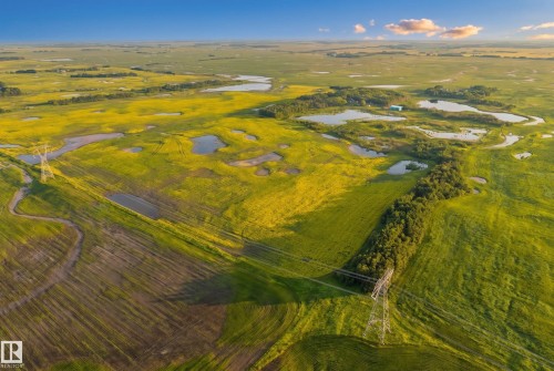 Expansive agricultural landscape featuring large cultivated fields and natural wetlands - 48109 Rr 155, Rural Beaver County, AB - Outdoor With View