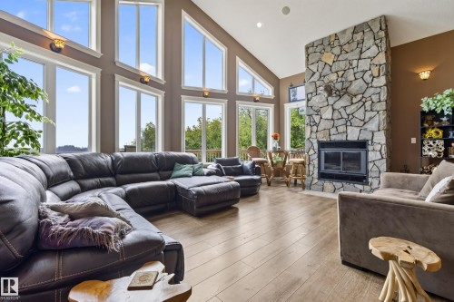 Spacious living area featuring a vaulted ceiling and expansive window wall - 48109 Rr 155, Rural Beaver County, AB - Indoor Photo Showing Living Room With Fireplace