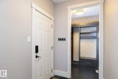 Built-in storage solutions with shelving, hanging space, and a lower drawer - 886 Armitage Wynd Sw, Edmonton, AB 