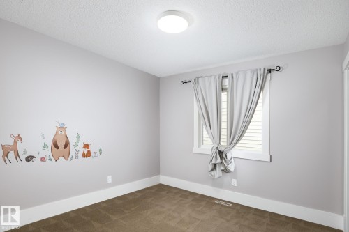 Neutral wall color, window with blinds, recessed lighting fixture, carpeted flooring, and white trim - 886 Armitage Wynd Sw, Edmonton, AB 