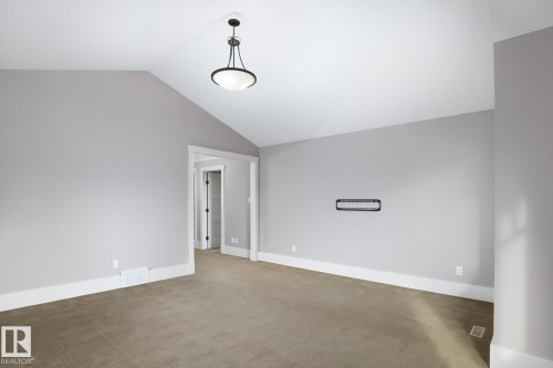 Vaulted ceiling, recessed lighting, neutral wall tones, carpeted flooring, and white trim - 886 Armitage Wynd Sw, Edmonton, AB 
