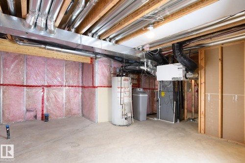 Exposed ceiling joists with extensive ductwork, water heater, water softener, and furnace system - 886 Armitage Wynd Sw, Edmonton, AB 
