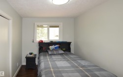 Wood-finish flooring, white trim, and a built-in closet with a solid white door - 