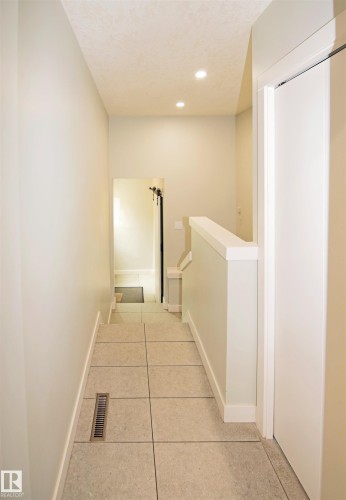 Recessed ceiling lighting, light-toned wall paint, tiled flooring, white trim, and a white interior door - 9657 68A Street Nw, Edmonton, AB 
