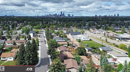 Residential neighborhood featuring a tree-lined street and distant cityscape - 9657 68A Street Nw, Edmonton, AB 