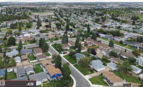 Residential neighborhood featuring mature trees, paved streets, and a mix of single-story homes - 9657 68A Street Nw, Edmonton, AB 