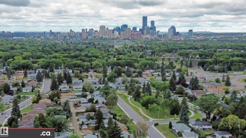 Expansive neighborhood setting featuring a dense tree canopy and a distant urban skyline - 9657 68A Street Nw, Edmonton, AB 