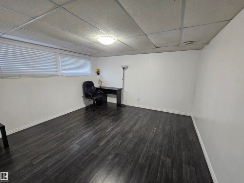 Wood-finish flooring, white walls, and a drop ceiling - 8828 151 Avenue Northwest, Edmonton, AB 
