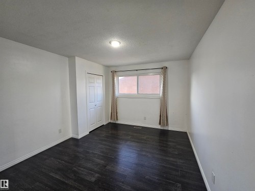 Dark wood-finish flooring with white walls - 8828 151 Avenue Northwest, Edmonton, AB 