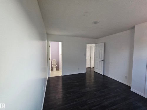 Dark wood-finish flooring with white walls - 8828 151 Avenue Northwest, Edmonton, AB 