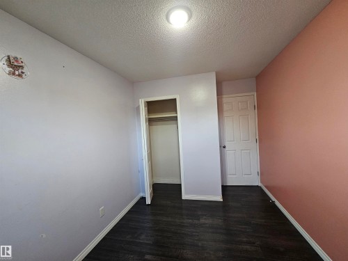Dark wood-finish flooring with white trim - 8828 151 Avenue Northwest, Edmonton, AB 