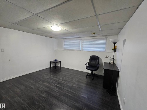 Wood-finish flooring, white painted walls, and a drop ceiling with integrated lighting - 8828 151 Avenue Northwest, Edmonton, AB 