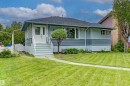 Exterior featuring a light-toned stucco and horizontal siding combination - 13024 Sherbrooke Avenue Nw, Edmonton, AB 