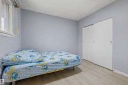 Recessed window, light-toned walls, and wood-finish flooring - 
