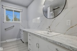 Vanity with an integrated sink, polished chrome faucet, and white cabinetry - 