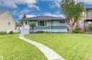 Single-story residence featuring a gray exterior with horizontal siding, white trim, and a dark shingle roof - 13024 Sherbrooke Avenue Nw, Edmonton, AB 